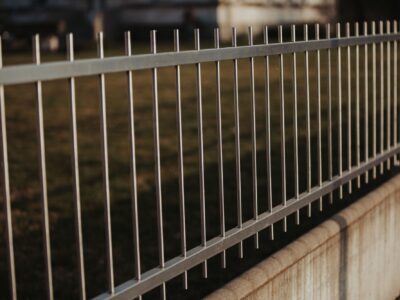 Black metal fencing around the park